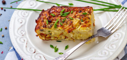 Piece of potato kugel on a plate.