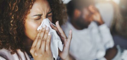 Woman sneezing from winter allergies